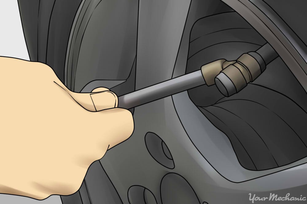 hand removing some tire pressure