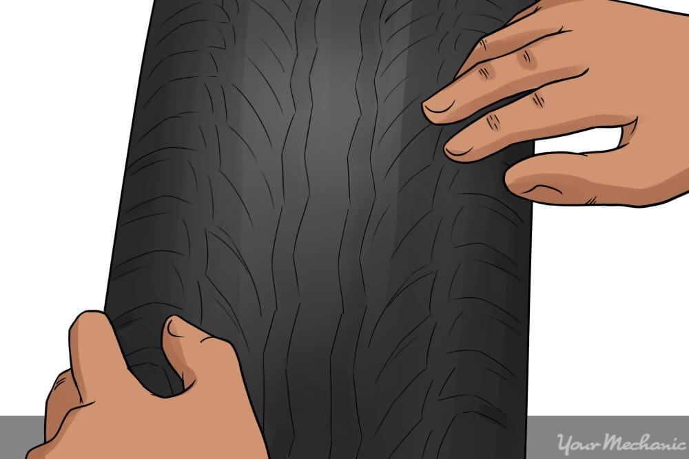 close up of person inspecting tire