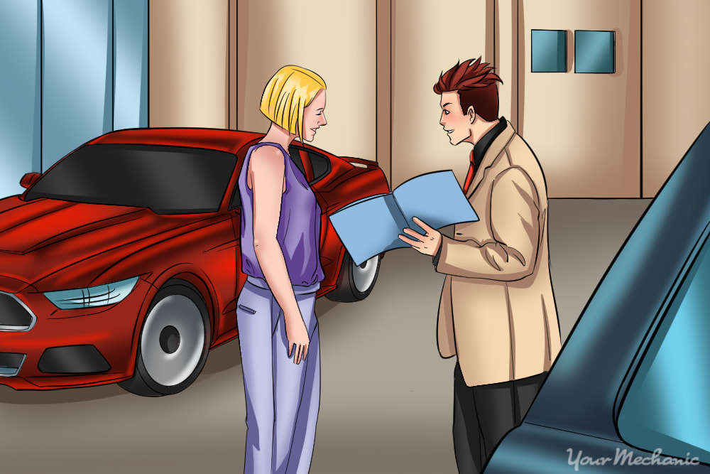 woman speaking with a car salesman