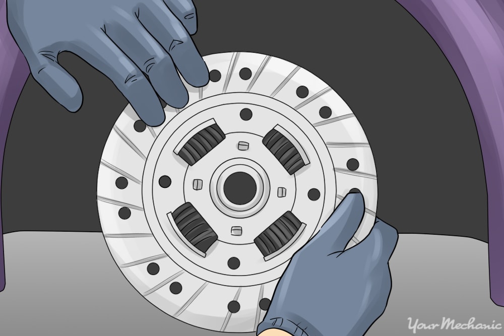 person replacing clutch disc