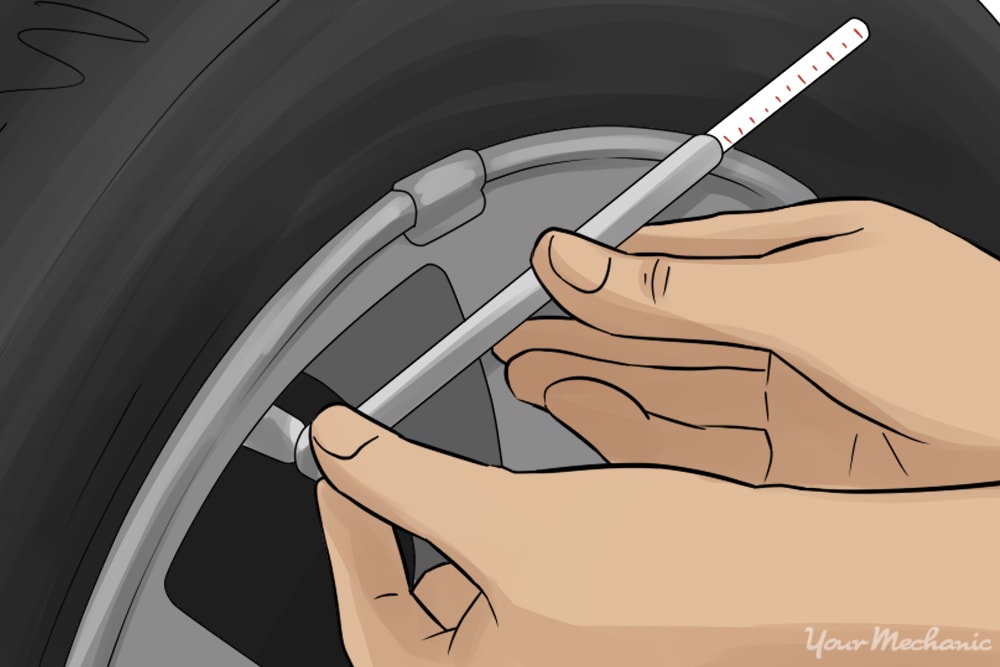 hand holding tire pressure gauge