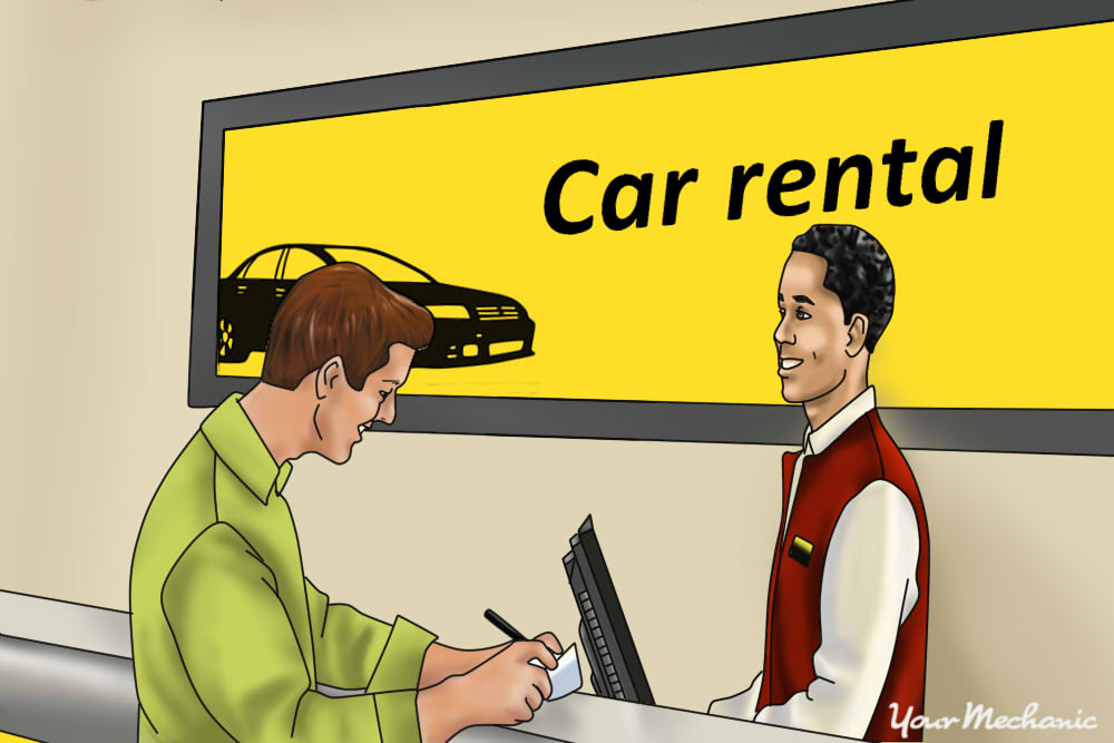 man signing a rental car contract