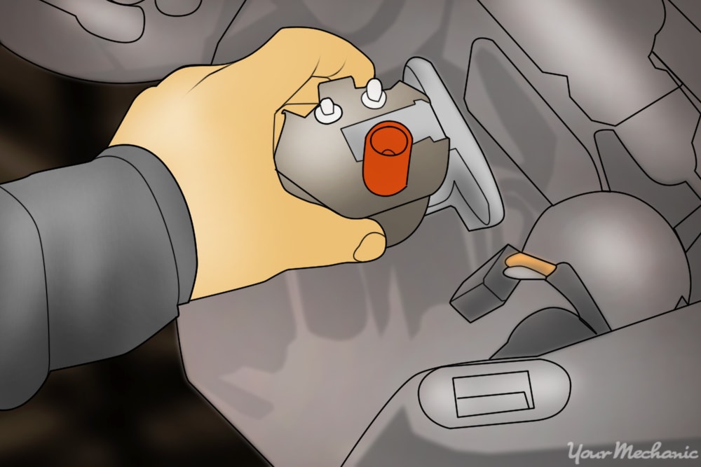 person removing ignition coil from engine