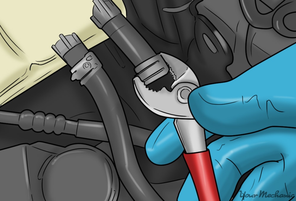 coolant reservoir hose being removed using pliers