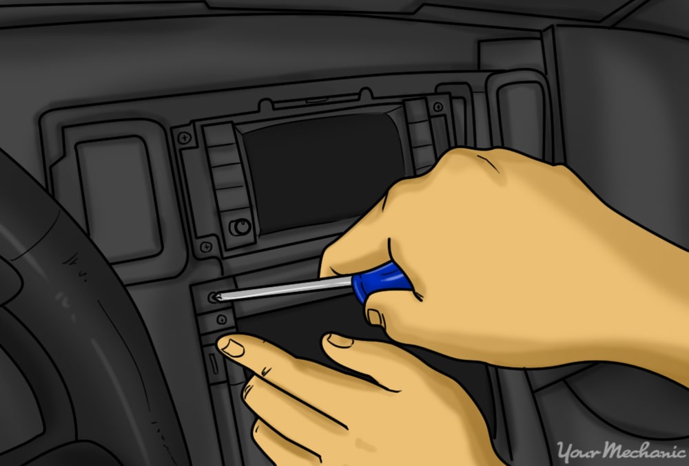 person removing screws that secure oem head unit