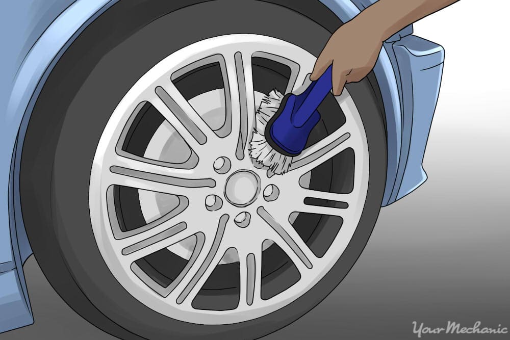 person scrubbing between wheel spokes