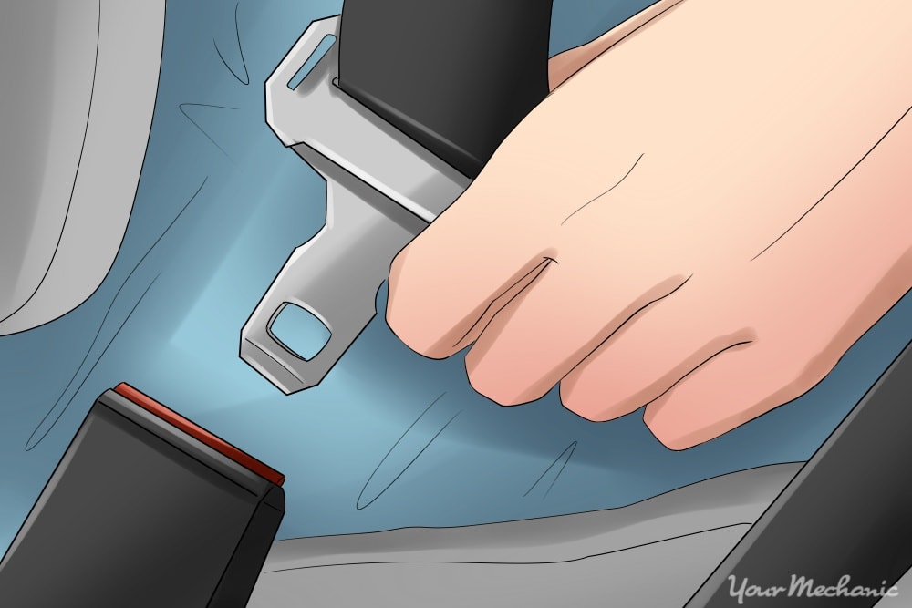 close up of hand unbuckling seat belt