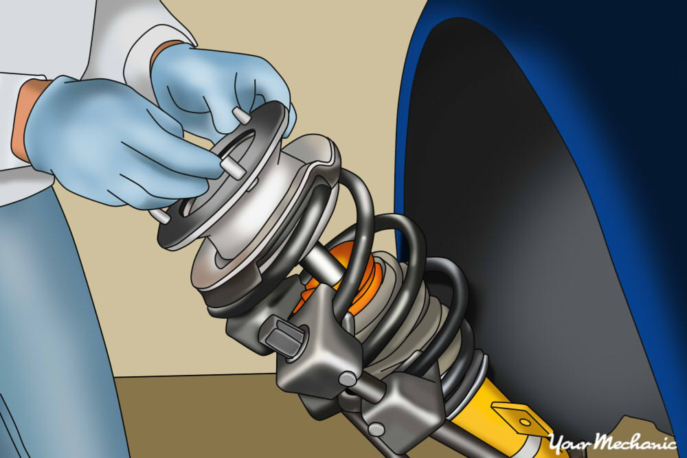 person removing the strut assembly from car