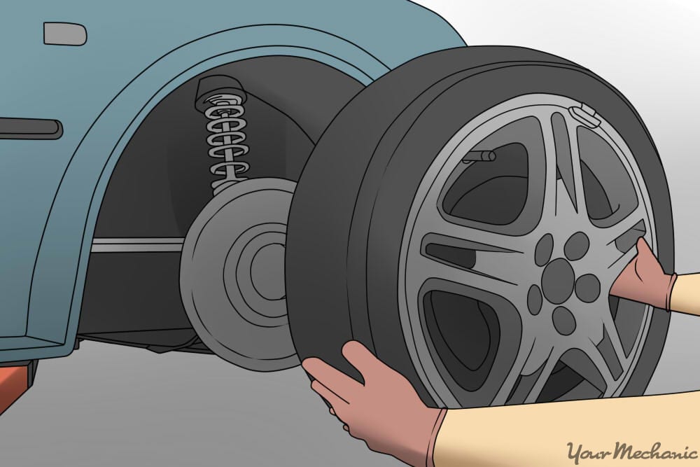 person removing car wheel