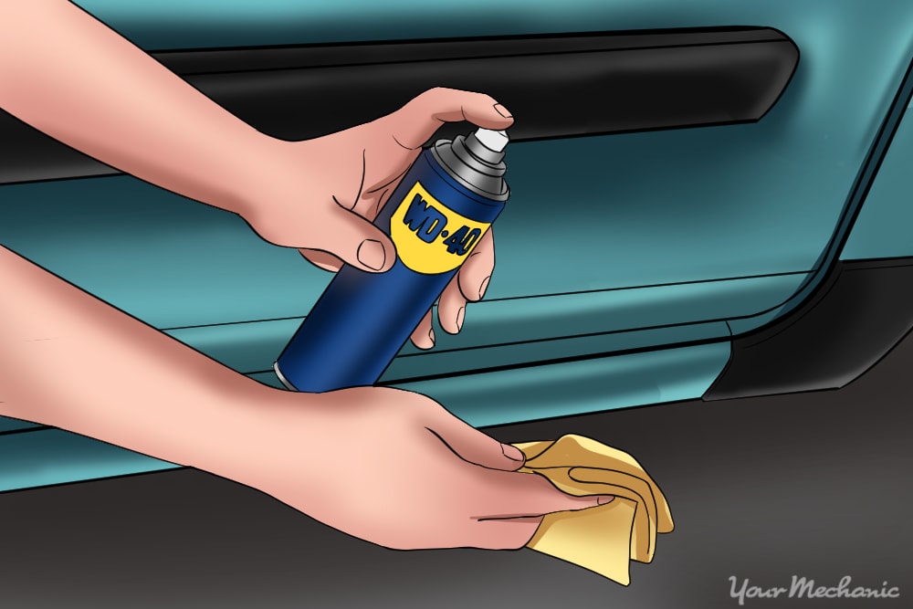 person holding wd-40 and rag in hand