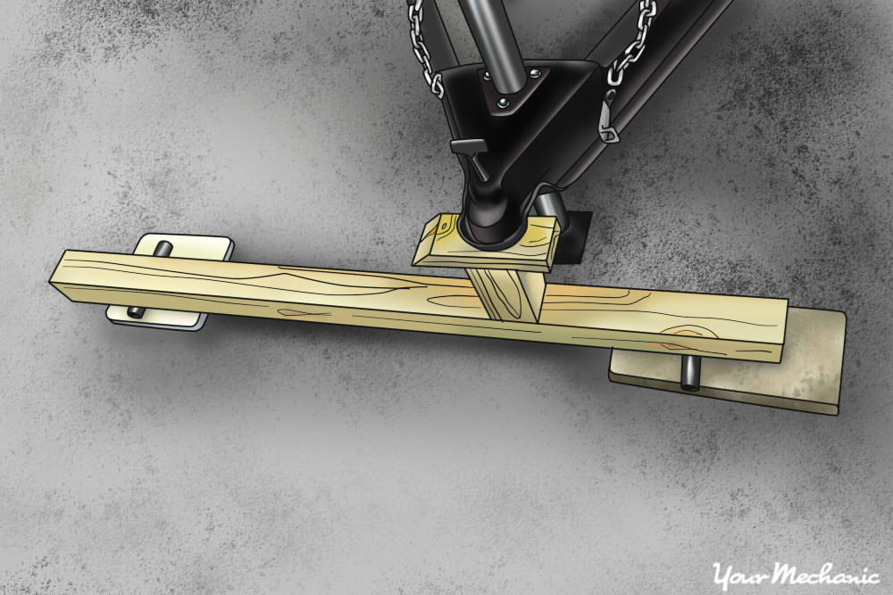 https://res.cloudinary.com/yourmechanic/image/upload/dpr_auto,f_auto,q_auto/v1/article_images/4_How_to_Select_a_Trailer_Hitch_close_up_of_a_trailer_coupler_resting_on_board_laid