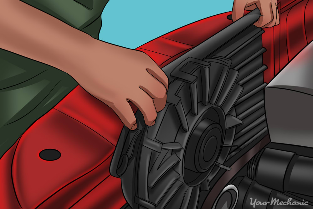 mechanic removing cooling fan assembly from vehicle