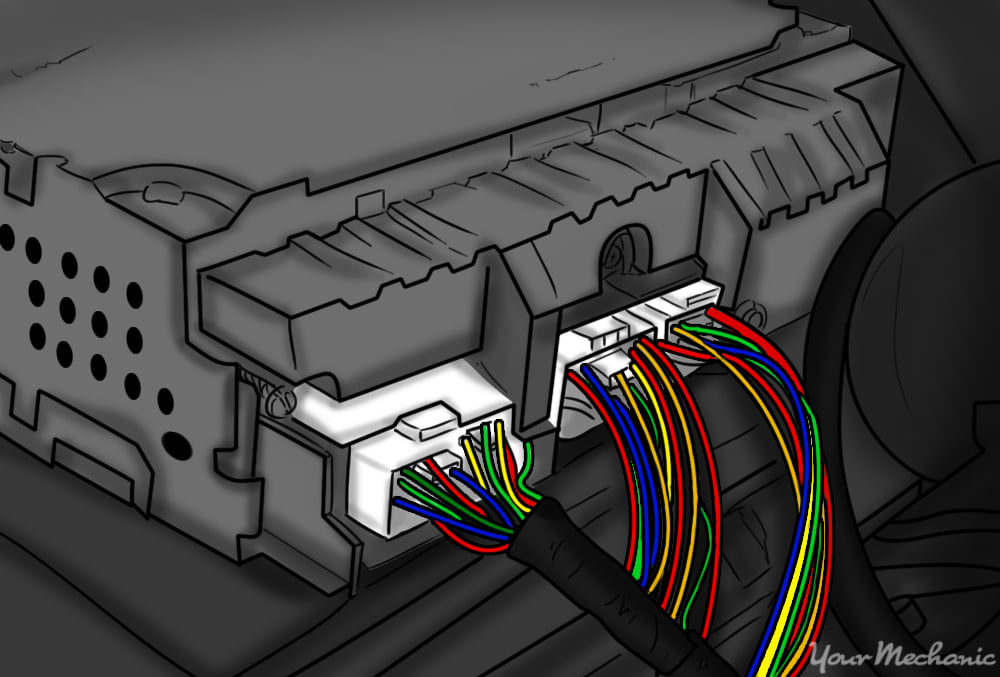 rear of a stereo head unit showing multiple connectors that need to be unplugged