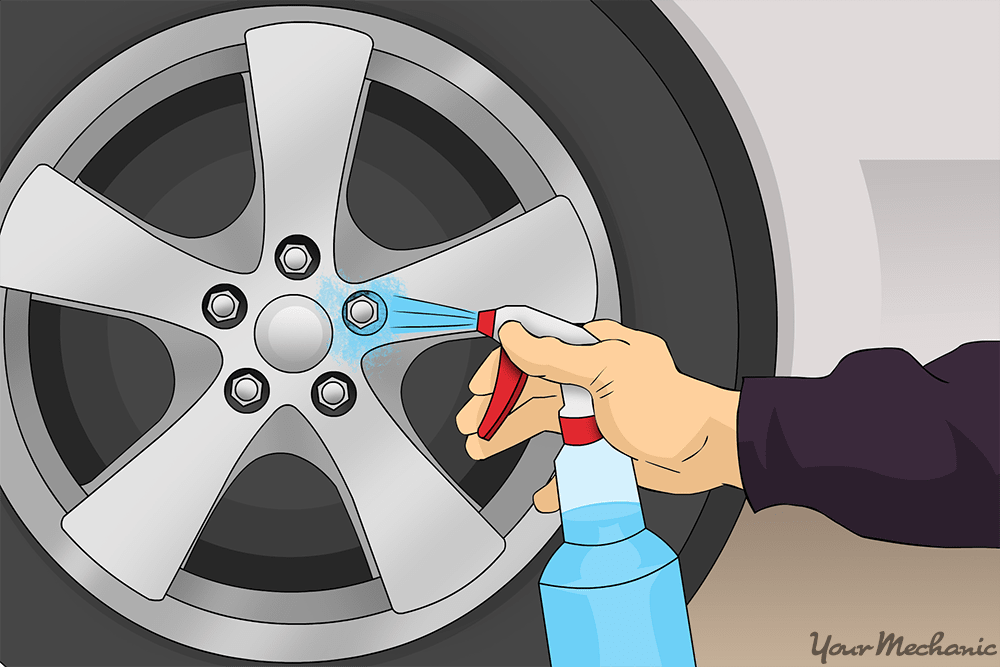 person applying cleaner onto wheel