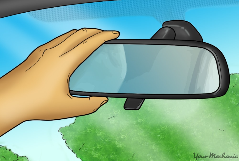 hand adjusting rearview mirror