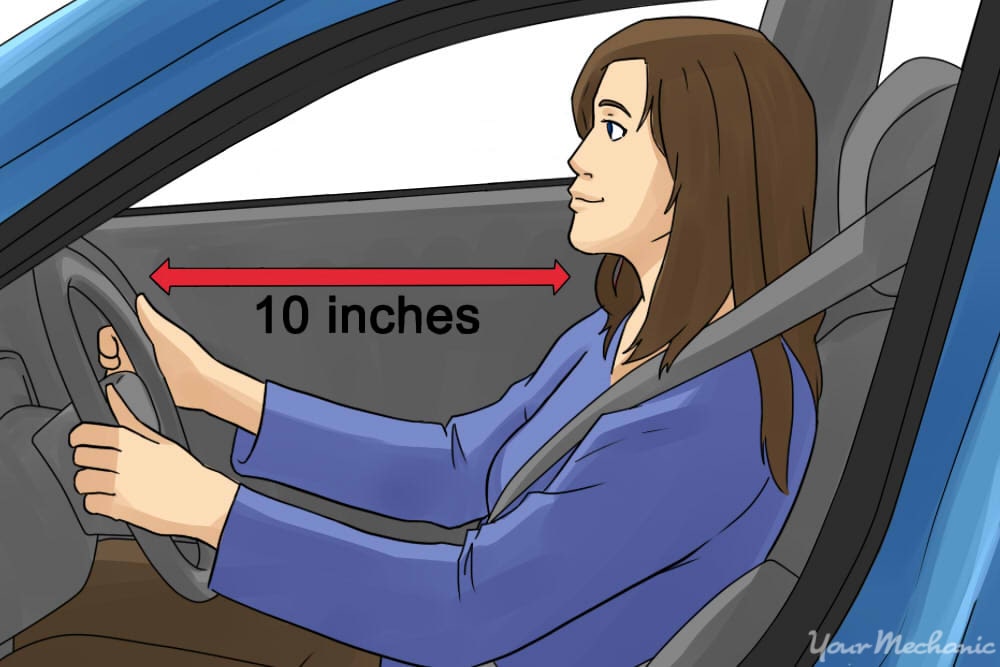 woman driving with distance between her and the steering wheel labeled