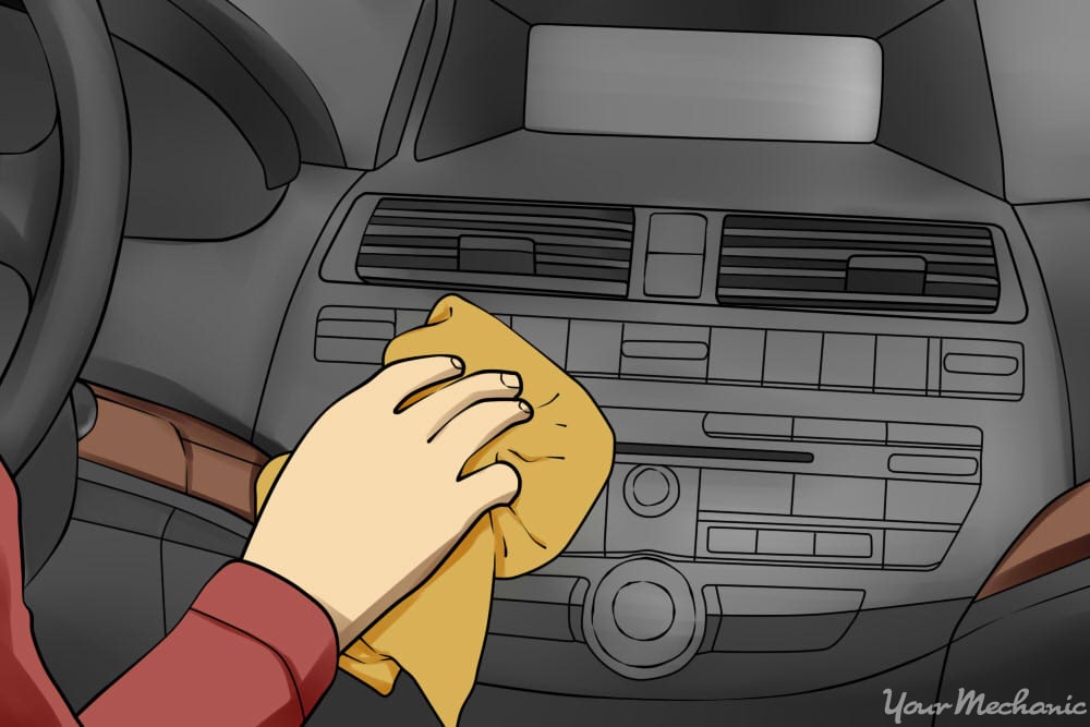 person wiping down car with a dry towel