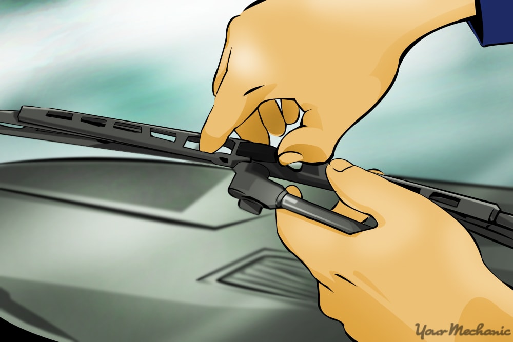 hands removing wiper blade from wiper arm