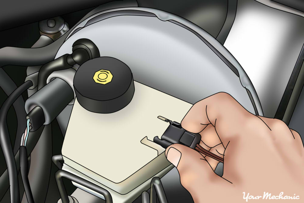 mechanic plugging electrical connector back into the brake pressure switch