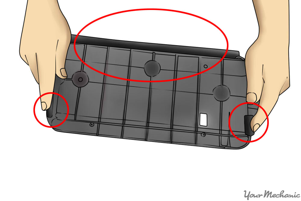 hands holding bracket with details circled