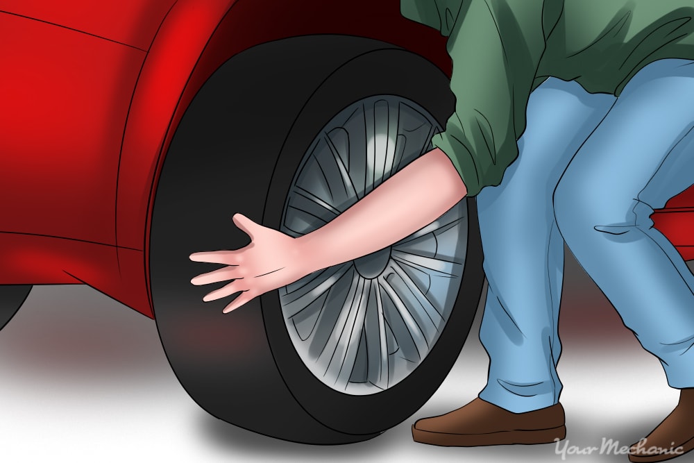 person grabbing tire