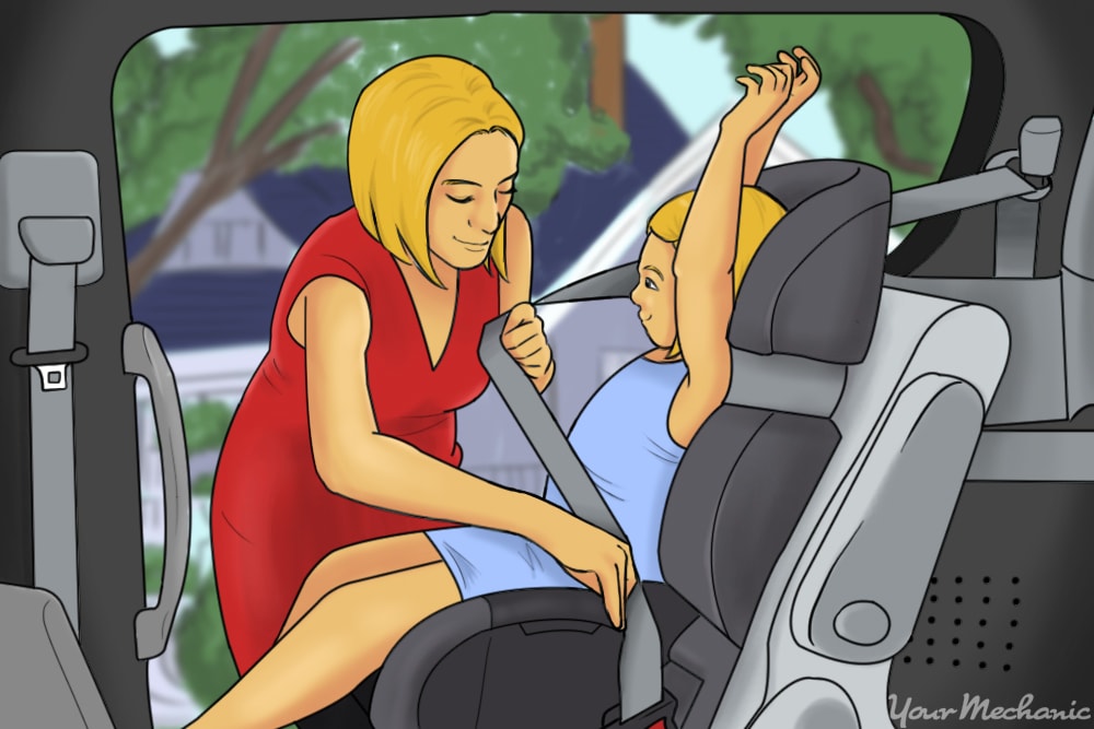 child being buckled into seat by mother