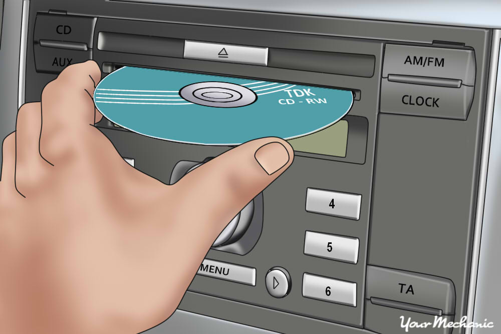 person sliding cd into player