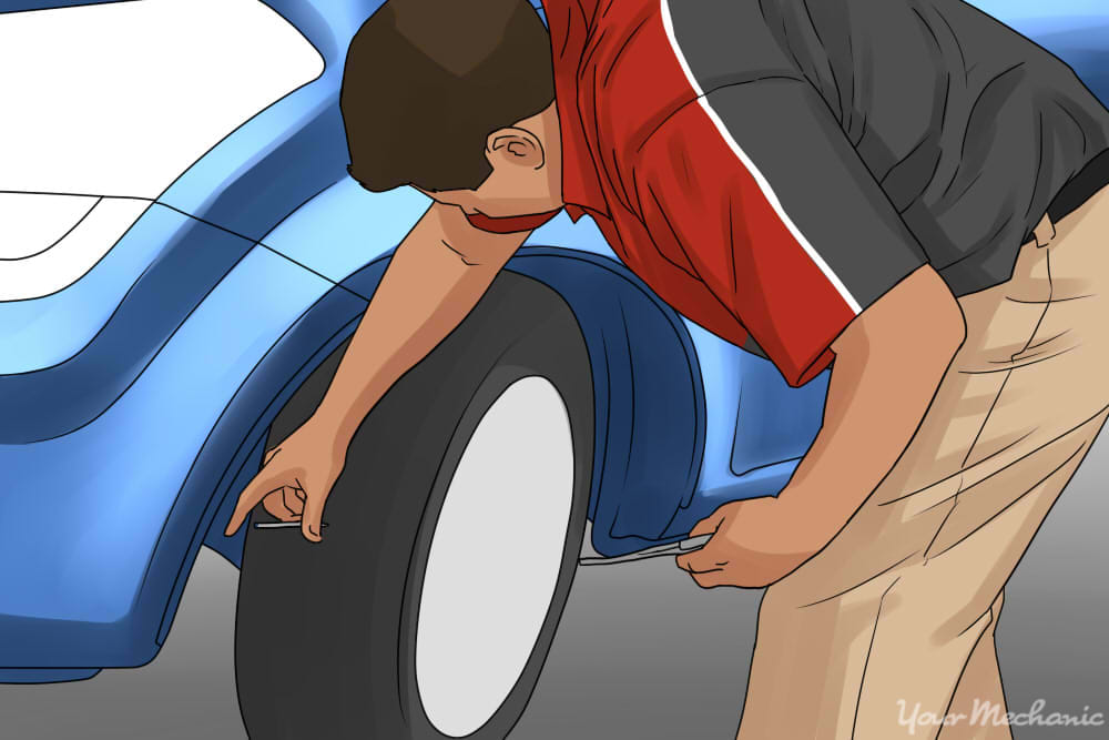 tire being inspected by a proffessional