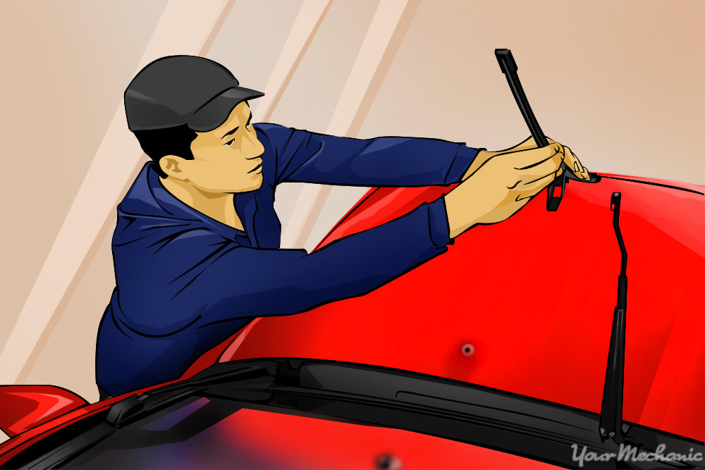 man installing new wiper blades onto arms