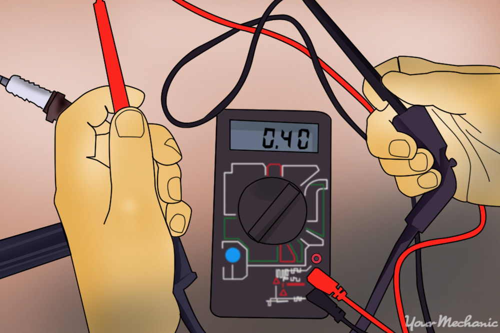 person testing a spark plug wire using a digital multimeter