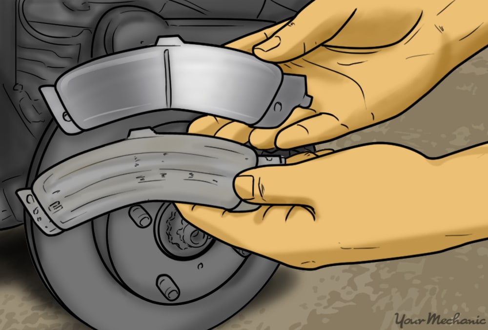 hands holding new brake pads