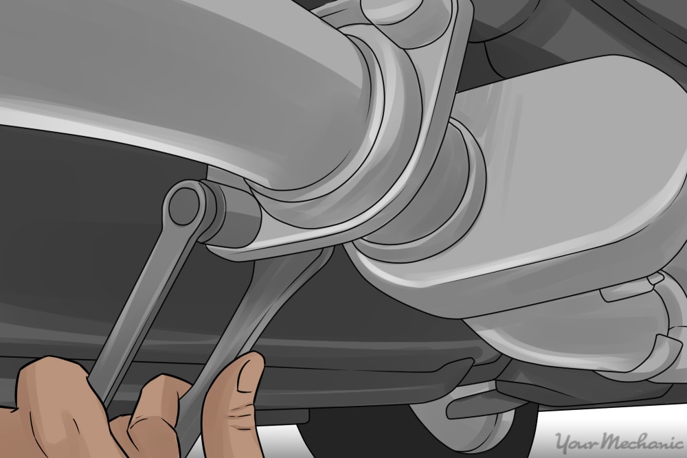 person removing bolts from an exhaust clamp