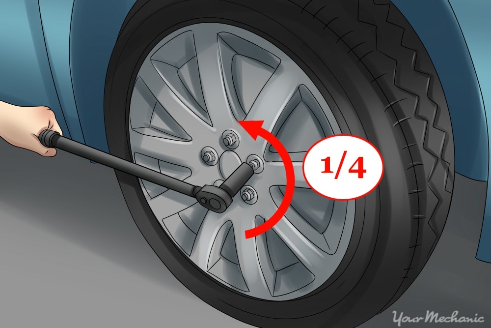 person using lug wrench on nuts