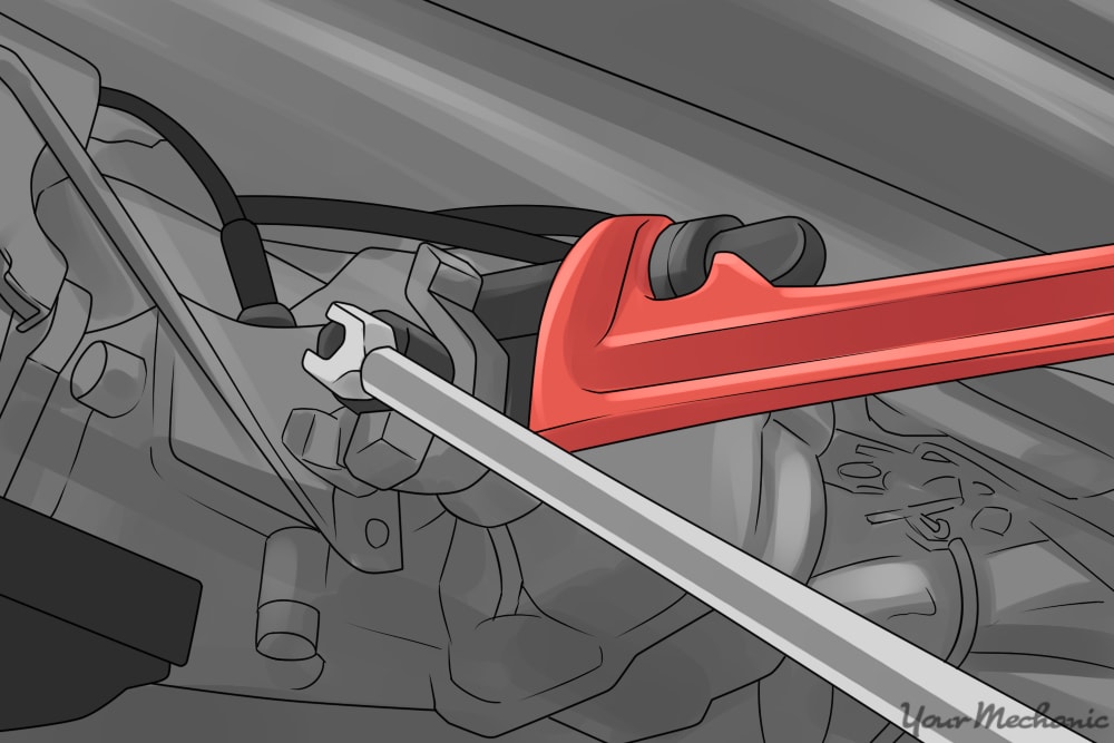 removing yoke nut with socket and breaker bar while holding yoke with a large pipe wrench