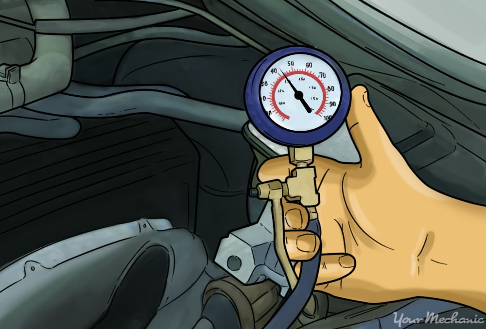 hand holding a pressure tester attached to an engine showing pressure