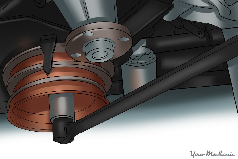 ratchet and socket being used to turn a crankshaft pulley