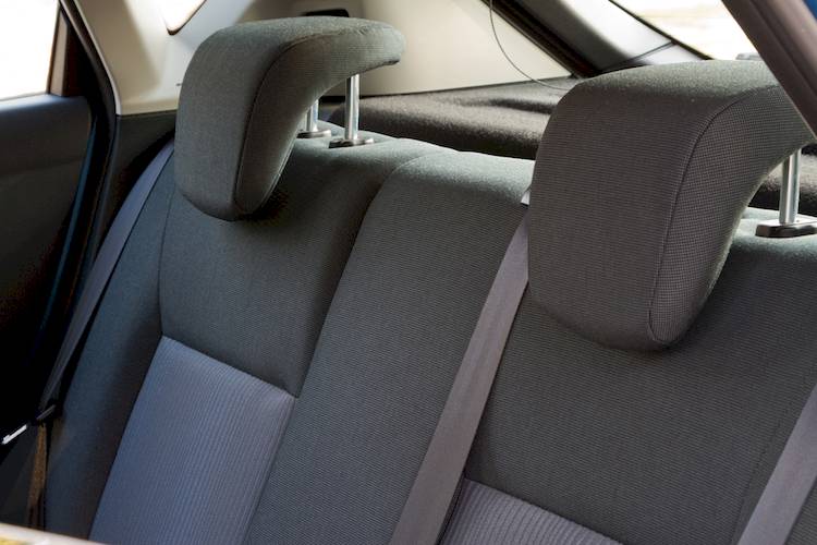 Why are headrests important (and uncomfortable) in modern vehicles?