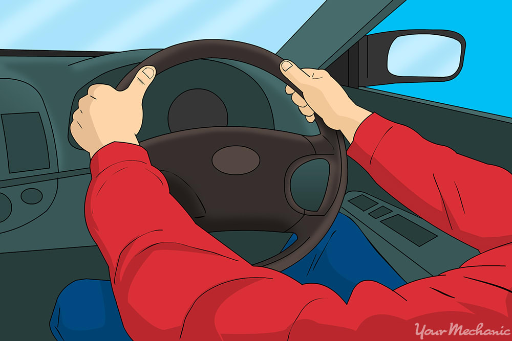 person holding onto steering wheel