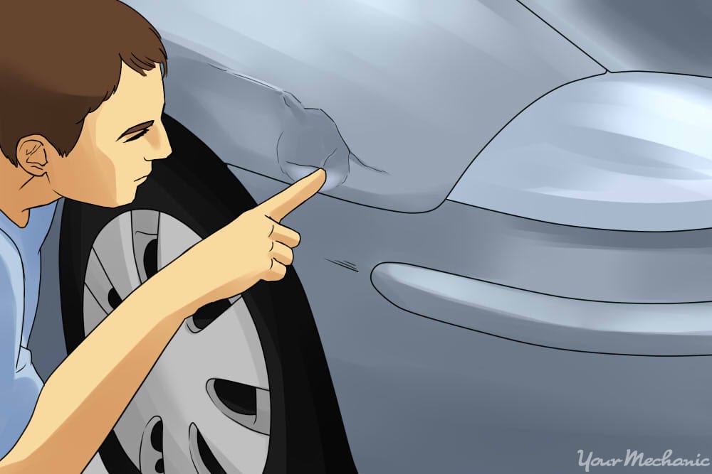 inspecting a dent on the side of a car