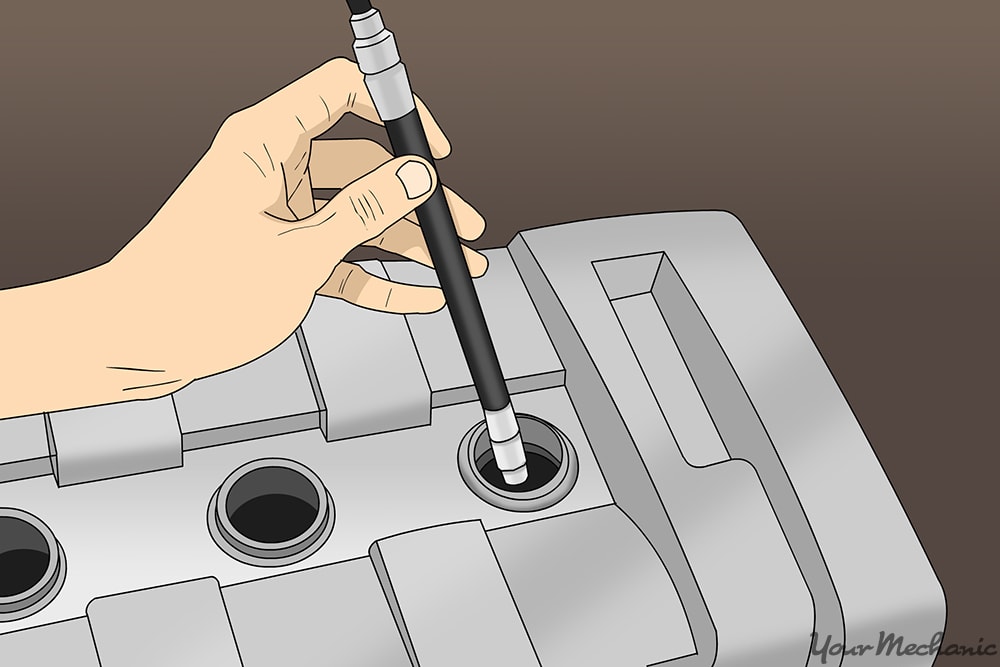 compression gauge being threaded by hand