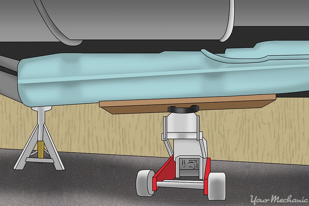 transmission jack being used on a fuel tank