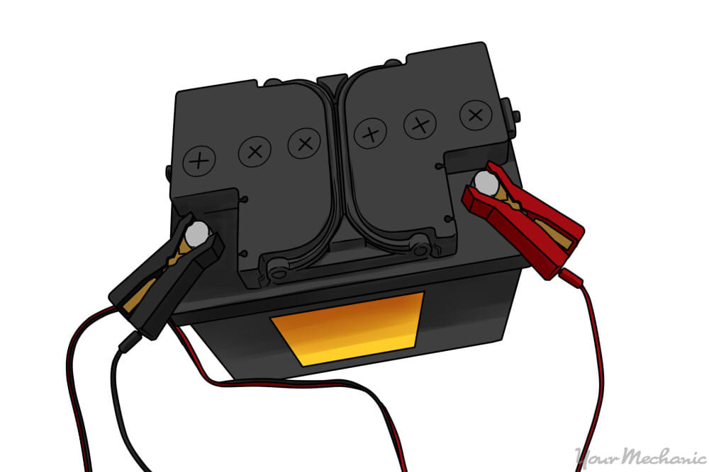 battery with positive and negative clamps attached