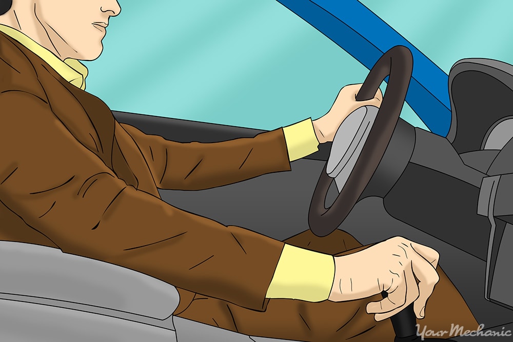 driver with hand on steering wheel and shifter