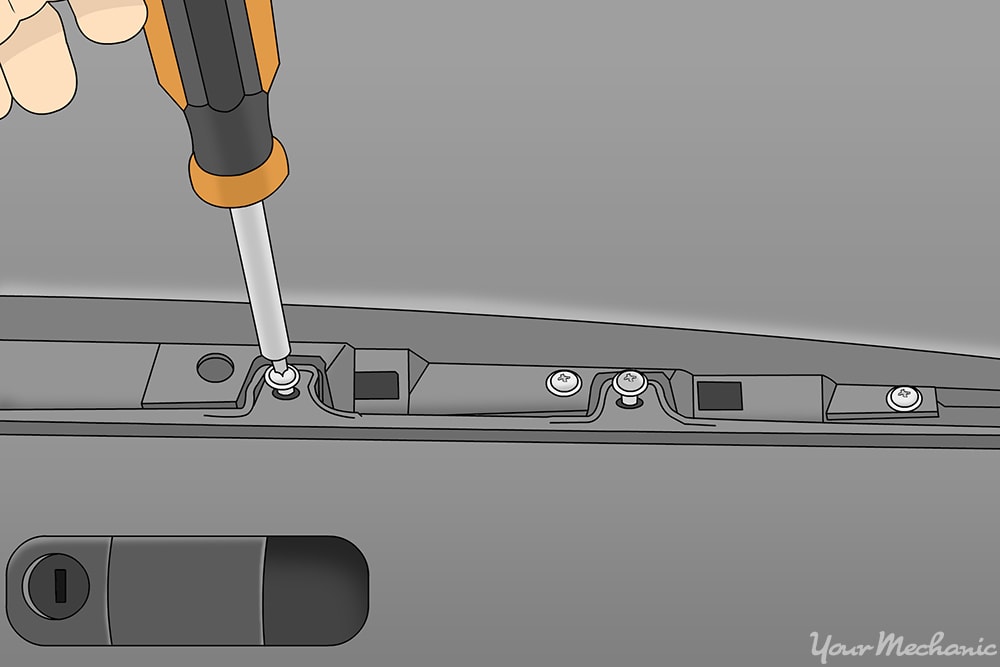 hand replacing screws to put finishing panel above glove box back into dash