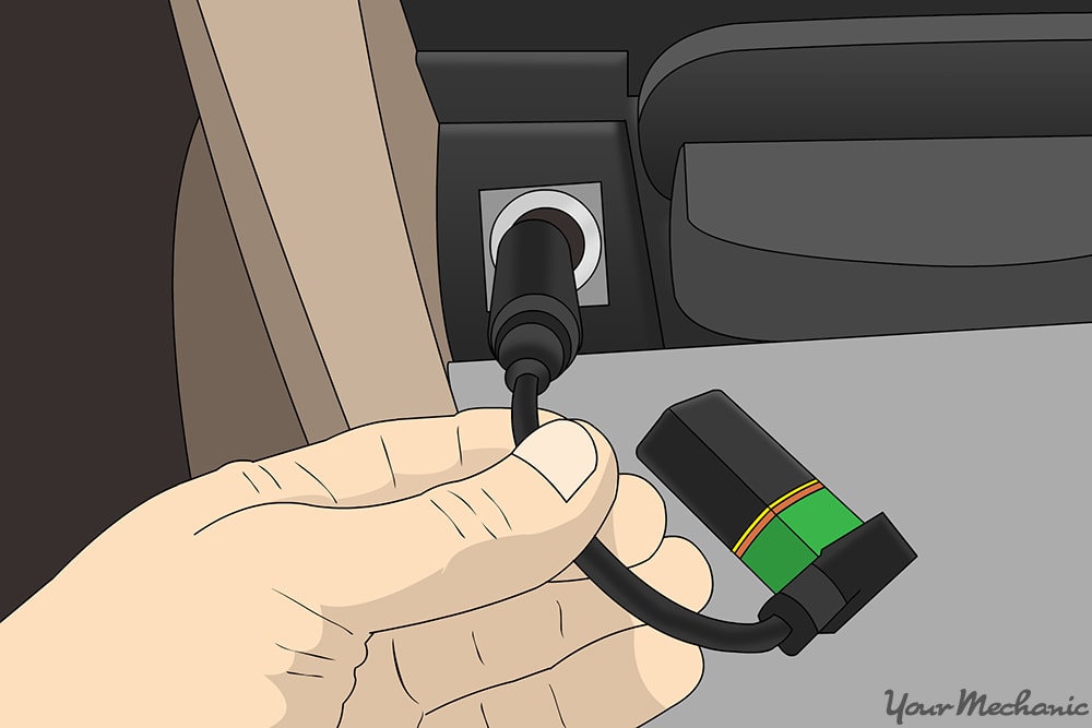 hand connecting the battery saver to the cigarette lighter