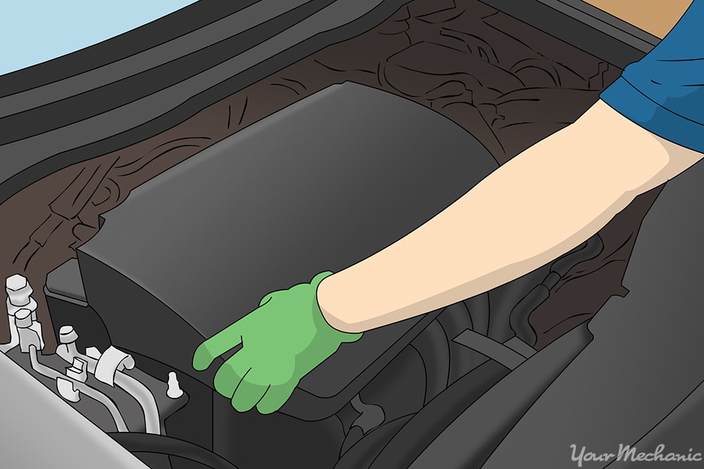 hands removing an engine cover