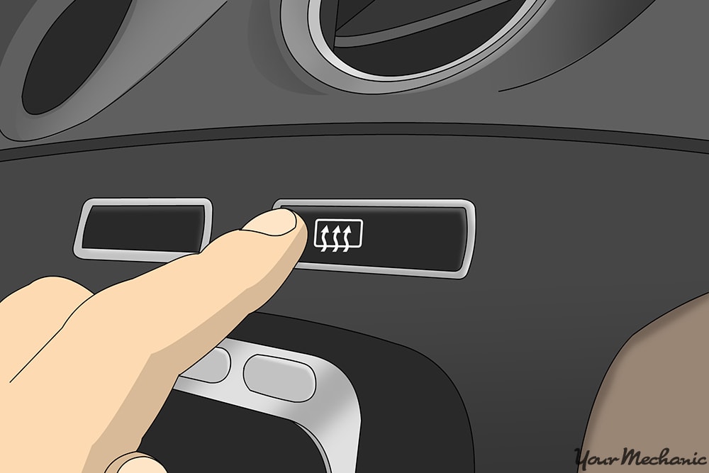 close up of finger pressing he defroster button