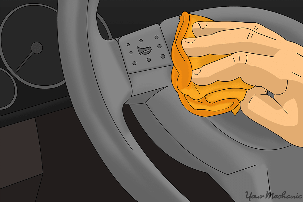 close up of hand cleaning steering wheel