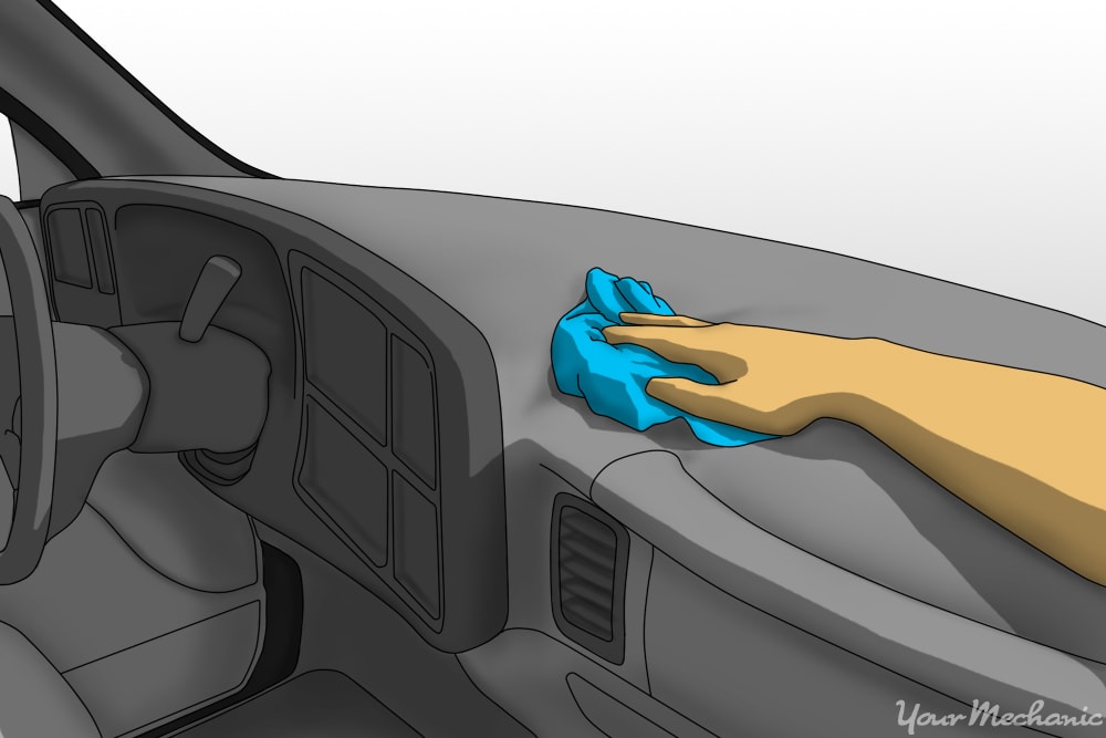 person cleaning top of dash