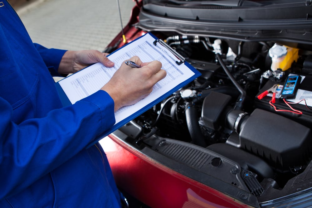 Technician performing vehicle inspection